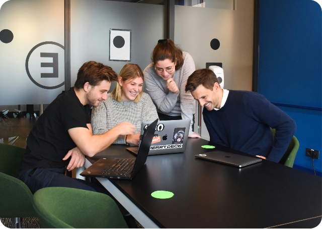 Group of people looking at laptop